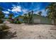 Light green exterior home with a white garage door, surrounded by lush tropical landscaping and a shell driveway at 8709 9Th Nw Ave, Bradenton, FL 34209