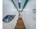 View of a long hallway with colorful painted ceiling and wooden floor at 8709 9Th Nw Ave, Bradenton, FL 34209