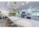 Kitchen featuring a large quartz bar with seating, modern appliances, and open to the dining room at 8709 9Th Nw Ave, Bradenton, FL 34209