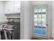 Laundry room featuring modern appliances and access to the backyard at 8709 9Th Nw Ave, Bradenton, FL 34209
