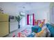 Bright living space featuring a retro refrigerator, TV and access to the outdoor porch at 8709 9Th Nw Ave, Bradenton, FL 34209