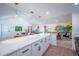Open floor plan features kitchen island, living room, and dining space for entertaining at 8709 9Th Nw Ave, Bradenton, FL 34209