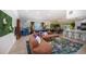 Open-concept living space featuring modern furnishings, a pool table, a dining area and bright, vibrant decor at 8709 9Th Nw Ave, Bradenton, FL 34209