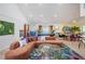 Open living area with a pool table, comfortable seating, bright accents, and a view of the backyard at 8709 9Th Nw Ave, Bradenton, FL 34209