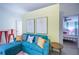 Inviting living room with beach-themed decor and comfortable seating, open to the bedroom at 8709 9Th Nw Ave, Bradenton, FL 34209
