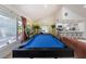 Bright living room with pool table, plank flooring, breakfast bar, and access to outside patio at 8709 9Th Nw Ave, Bradenton, FL 34209