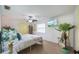 Bright bedroom features a ceiling fan, television, and large tropical plants at 8709 9Th Nw Ave, Bradenton, FL 34209