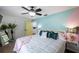 Bright bedroom features light colored walls, ceiling fan, and tropical plants at 8709 9Th Nw Ave, Bradenton, FL 34209