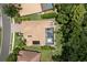 An aerial view of a home with a screened-in pool, solar panels, and mature trees for privacy at 8840 Brookfield Ter, Bradenton, FL 34212