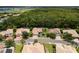 Expansive aerial view of neighborhood homes with lush landscaping and a serene backdrop of trees and waterways at 8840 Brookfield Ter, Bradenton, FL 34212