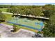 Aerial view of community basketball court with benches, parking, and lush landscaping at 8840 Brookfield Ter, Bradenton, FL 34212