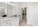 Bathroom featuring granite countertops, vanity, and doorway leading to bedroom at 8840 Brookfield Ter, Bradenton, FL 34212