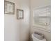 Cozy bathroom features neutral decor and natural light from the window with crisp white blinds at 8840 Brookfield Ter, Bradenton, FL 34212