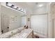 Bathroom featuring a granite countertop, framed mirror, and tiled shower with curtain at 8840 Brookfield Ter, Bradenton, FL 34212