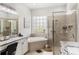 Luxurious bathroom with a soaking tub, walk-in shower, and dual vanities with granite countertops at 8840 Brookfield Ter, Bradenton, FL 34212