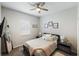 This bedroom features a ceiling fan, wood floors, and minimalist decor at 8840 Brookfield Ter, Bradenton, FL 34212