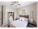 This bedroom features a walk-in closet, wood floors, a ceiling fan and soft pink accents at 8840 Brookfield Ter, Bradenton, FL 34212