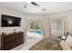 Bedroom featuring a ceiling fan, and sliding doors to the outdoor pool area with outdoor seating at 8840 Brookfield Ter, Bradenton, FL 34212
