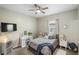 This bedroom features a bed with a vanity, ceiling fan, tv and closet at 8840 Brookfield Ter, Bradenton, FL 34212