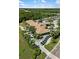 Aerial view of the beautiful clubhouse surrounded by lush landscaping and parking at 8840 Brookfield Ter, Bradenton, FL 34212
