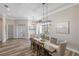 Inviting dining space with modern lighting and views to the foyer and a set of french doors at 8840 Brookfield Ter, Bradenton, FL 34212