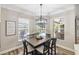 Bright dining room with stylish chandelier and backyard pool views through large windows at 8840 Brookfield Ter, Bradenton, FL 34212