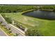 An aerial view of a driving range and lake at the community golf course at 8840 Brookfield Ter, Bradenton, FL 34212