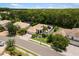 Aerial view of a well maintained home with a tile roof, mature landscaping, and screened-in pool at 8840 Brookfield Ter, Bradenton, FL 34212