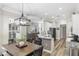 Open concept kitchen with granite countertops, stainless steel appliances, and view to the Gathering room at 8840 Brookfield Ter, Bradenton, FL 34212