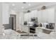 Kitchen with white cabinets, granite countertops, stainless steel appliances, and modern tile backsplash at 8840 Brookfield Ter, Bradenton, FL 34212