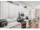 Kitchen features granite countertops, stainless appliances, and white cabinetry with modern hardware at 8840 Brookfield Ter, Bradenton, FL 34212