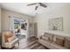 This living room has wood floors and a sliding glass door to the outdoor patio at 8840 Brookfield Ter, Bradenton, FL 34212
