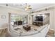 Comfortable living room with large sectional sofa, a modern entertainment center, and sliding glass doors at 8840 Brookfield Ter, Bradenton, FL 34212