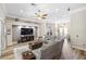 Spacious living room featuring a sectional sofa, an entertainment center, and a ceiling fan at 8840 Brookfield Ter, Bradenton, FL 34212