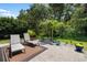 Serene patio showcasing lounge chairs amid lush greenery, offering a peaceful outdoor escape at 8840 Brookfield Ter, Bradenton, FL 34212