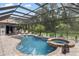 Beautiful screened pool with an integrated spa, surrounded by ample space and lush greenery at 8840 Brookfield Ter, Bradenton, FL 34212