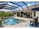 Stunning pool with a spa, a screened enclosure, and an outdoor entertainment area at 8840 Brookfield Ter, Bradenton, FL 34212
