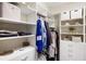 Walk-in closet with custom shelves, hanging racks and ample storage space at 8840 Brookfield Ter, Bradenton, FL 34212