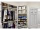 Walk-in closet with custom shelves and hanging racks for ample storage at 8840 Brookfield Ter, Bradenton, FL 34212