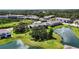 Expansive aerial view showcasing the property's townhomes, with lush trees, ponds, and green spaces at 8979 Milestone Dr, Sarasota, FL 34238