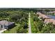 Aerial shot of a walking path lined with lush trees, offering a blend of nature and community living at 8979 Milestone Dr, Sarasota, FL 34238