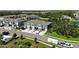 Overhead shot of townhomes, attached garages, verdant lawns, and a captivating pond with a fountain feature at 8979 Milestone Dr, Sarasota, FL 34238