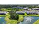 Beautiful aerial view of the townhomes with a fountain pond, swimming pool, and lush green landscaping at 8979 Milestone Dr, Sarasota, FL 34238