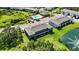 Overhead view features modern townhome exteriors, manicured lawns, and a tranquil pond at 8979 Milestone Dr, Sarasota, FL 34238
