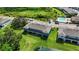 An elevated view showcasing a well-maintained townhome with manicured green lawn, and a pond at 8979 Milestone Dr, Sarasota, FL 34238