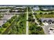 Overhead view reveals a scenic trail surrounded by lush greenery with community buildings nearby at 8979 Milestone Dr, Sarasota, FL 34238