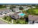 A beautiful aerial view of the community pool, clubhouse, and nearby townhomes in a well maintained community at 8979 Milestone Dr, Sarasota, FL 34238