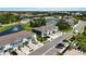 Overhead perspective of townhomes, garages, landscaped lawns, and a delightful pond accented by a beautiful fountain at 8979 Milestone Dr, Sarasota, FL 34238