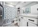 Bright bathroom featuring a shower with a decorative curtain, white cabinets, and a large mirror at 8979 Milestone Dr, Sarasota, FL 34238