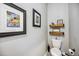 Bathroom showcasing art, decorative shelves and a toilet with coordinated accessories at 8979 Milestone Dr, Sarasota, FL 34238